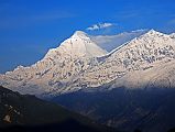 05 Dhaulagiri And Tukuche Peak After Sunrise From Kharka On Way To Mesokanto La Clouds obscured the view of Dhaulagiri at sunrise from our camp on the kharka (3460m) above Jomsom on the way to Tilicho Lake. However, the clouds dissipated after sunrise to reveal the bright white north face of Dhaulagiri and Tukuche Peak.